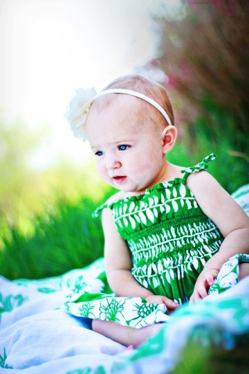 baby in green grass with green dress
